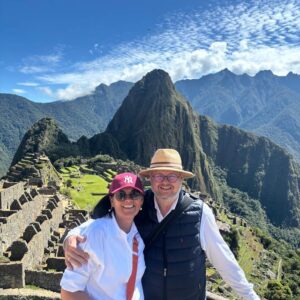Couple posing at Machu Picchu Circuit 2A with terraces and Huayna Picchu mountain